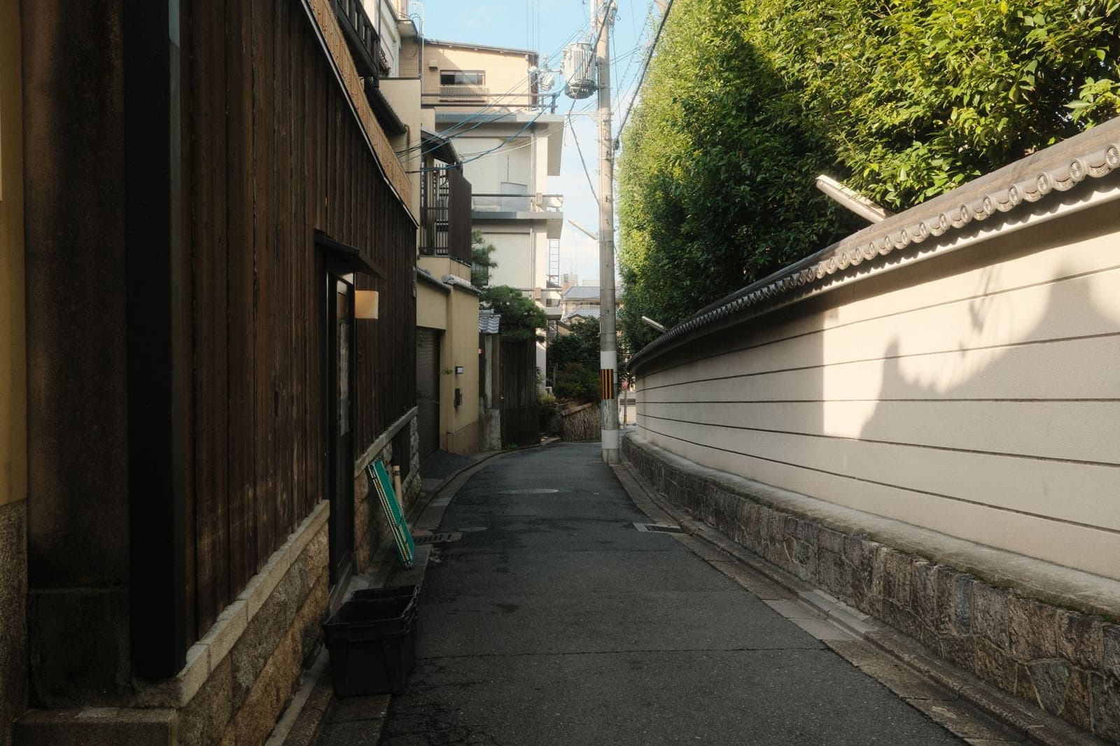 A narrow street with both sides already in shade.